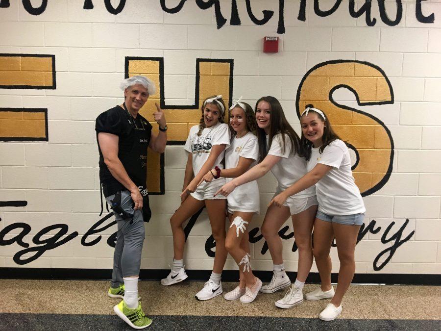 Sophomores Carly Burns, Abby Church, Avary Flynn, and Caroline Aversano show their class color, decked from head to toe in white as they point to principal Fultons white socks. Sophomore Carly Burns says I like dressing up for spirit days because it is a fun way to unify our school and have some fun for a week.