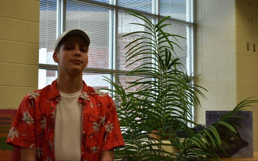 Freshman Lincoln Burkholder poses next to a palm tree lookalike for Sand v.s. Snow Day.