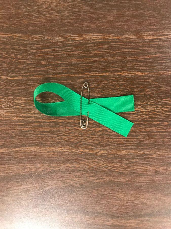 FBLA+members+made+green+ribbons+for+the+Gold+Rush+game+hosted+by+DECA+on+Friday.+Photos+by+Ava+Proehl.