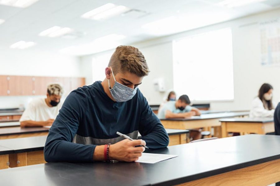 Students wear masks for the entirety of their SAT exam. The threat of COVID-19 prompted new safety measures to be set up in SAT testing environments all over the country. Photo provided by forbes.com. 
