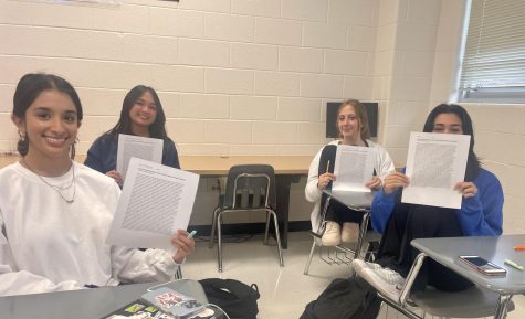 Sanjna Rachakonda, Nayana Raut, Evelynn Frisbee, and Angeline Jackson in Womens Studies reading a poem entitled Girl by Jamaica Kincaid. 