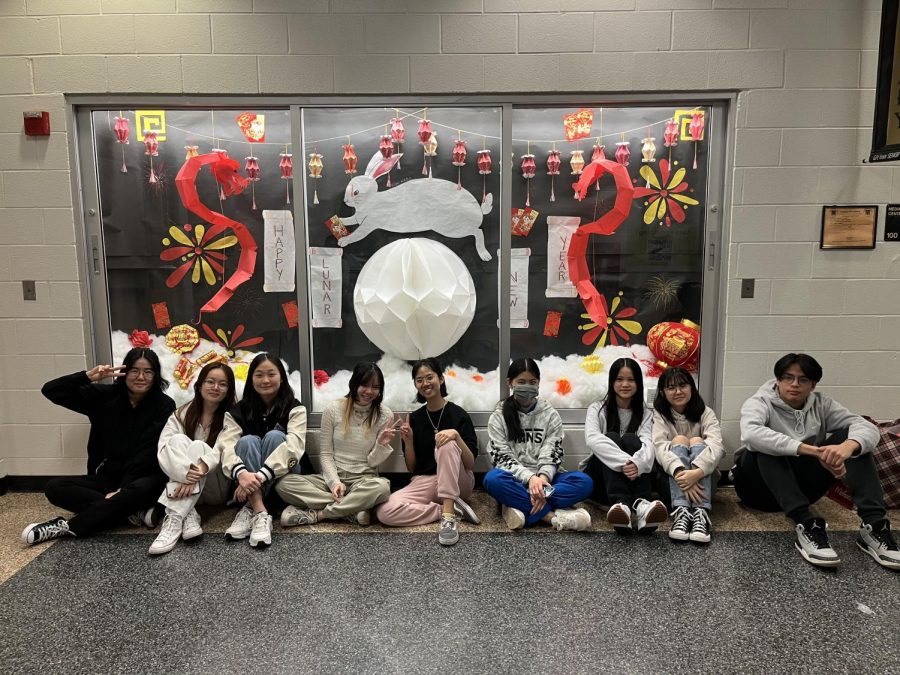 The Asian American Student Association poses in front of their Lunar New Year-inspired library display [Photographed by Hailey Chong] 