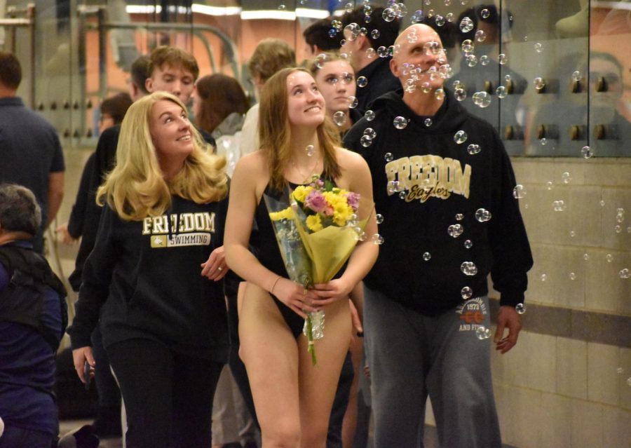 FHS+Senior+Kaylie+Thompson+and+her+parents+were+showered+in+bubbles+after+she+was+recognized+for+her+time+on+the+team.