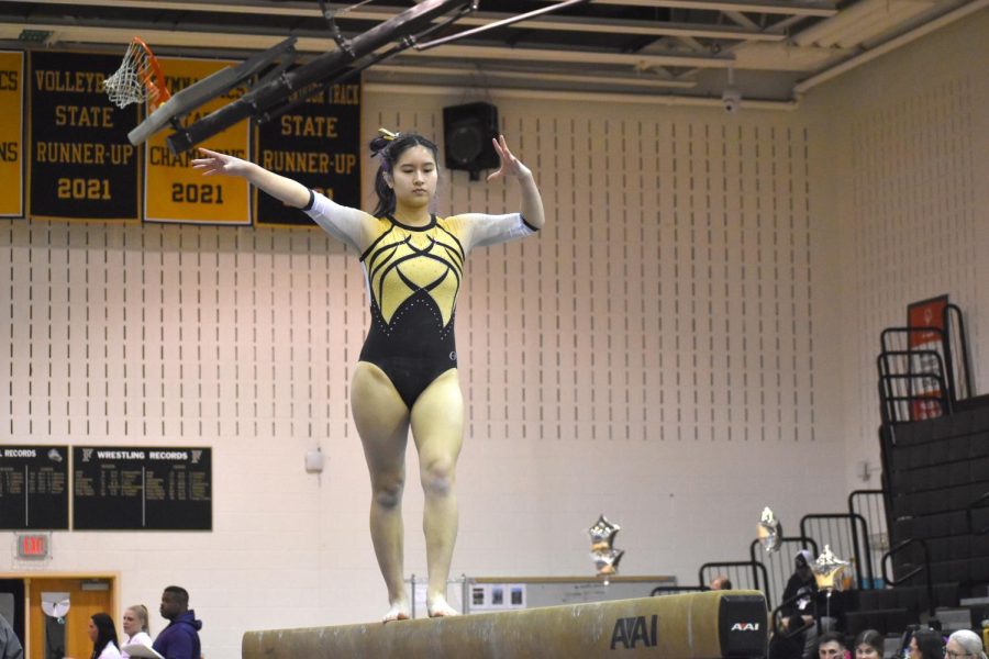 FHS+senior+Paulina+Pham+competes+on+beam+at+Districts+Meet.