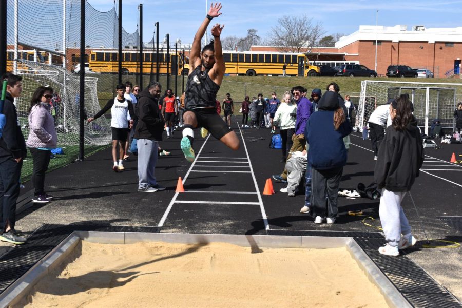 Visva Murali participating in the boys long jump at the Shamrock Invitational hosted by Dominion High School. 