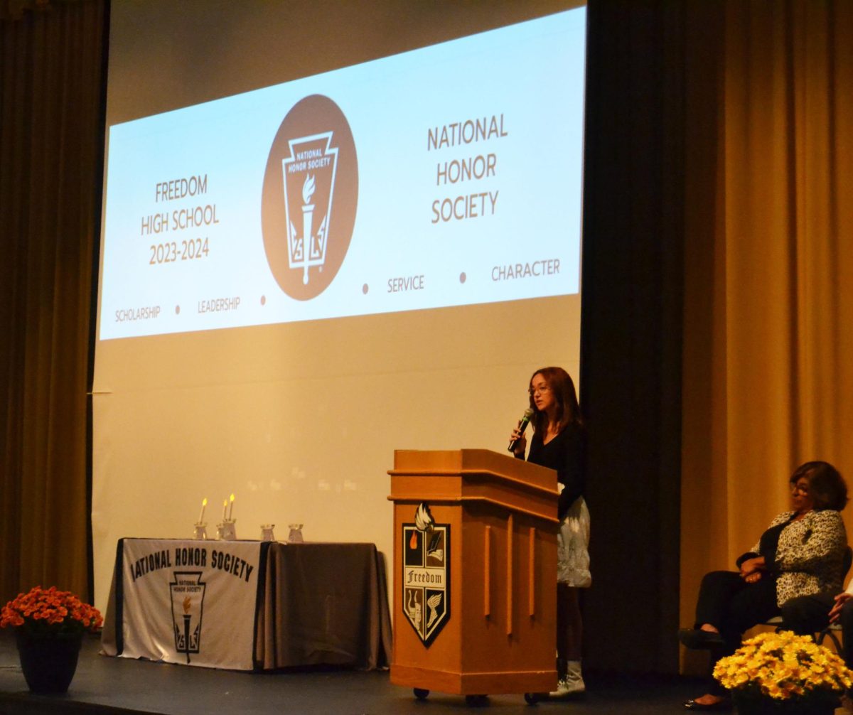 National Honor Society Historian Isabella Lopez recites one of the four pillars of the honor society. 