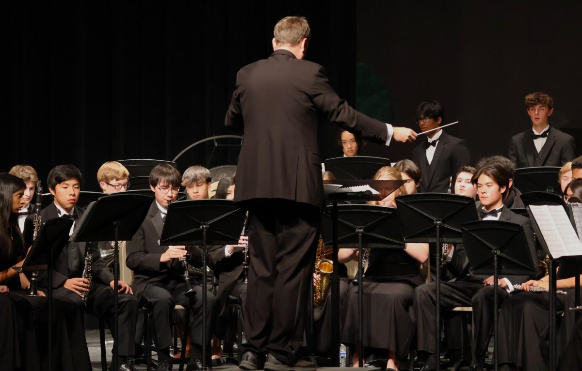 Jonathan Schiffler,FHS band directors, conducting the performance of the Artist Wind Ensemble. 
