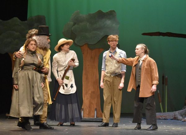 Lexi Gambardella playing Winnie Foster, Mahdi Bdairi playing Man In Yellow, Eliza Varanelli playing Mae Tuck, Riley Thompson playing Miles Tuck, and Maddie Amme playing Jesse Tuck on stage in Tuck Everlasting. 