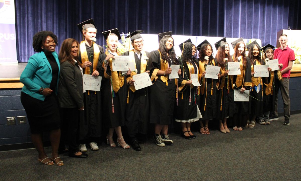 Freedom High School CAMPUS Seniors, CAMPUS counselor and CAMPUS teacher taking a group picture after graduation. 
