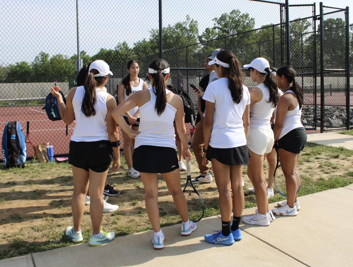Freedoms Girls Tennis having a team meeting before the start of the match.