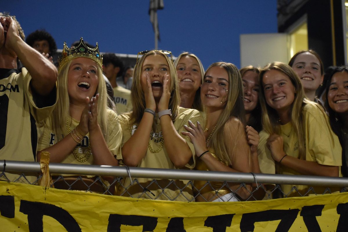 Seniors Jordyn Covey, Avery Greenfield, Madeline Fox, Emma Thacker, Lauren Parker, Mallory Bymers, and Peyton Kerns cheering for Freedom football at the Homecoming game against Riverside High School.