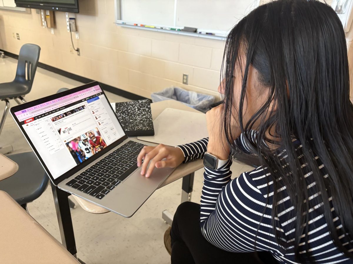 Senior Julia Li looking up the Washington Commanders' statistics.