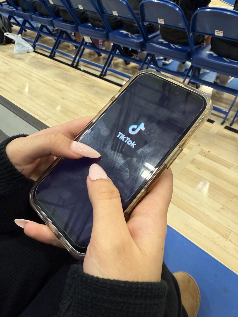 TikTok is loading on a student's phone screen. 