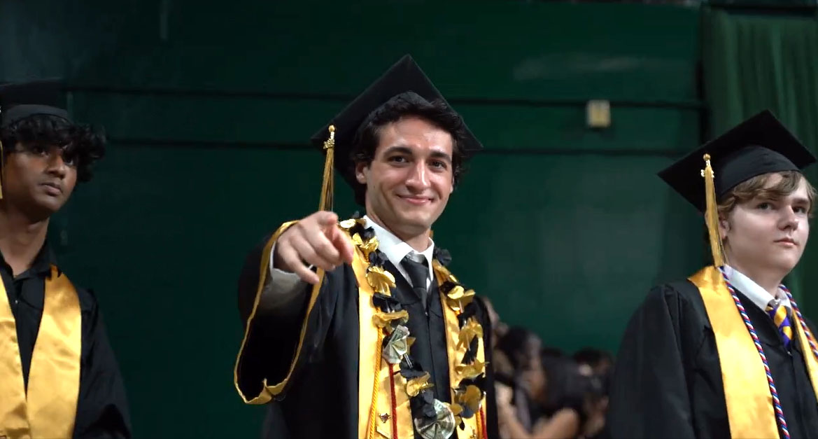 Suhas Adavelly, Aidan Starr and Alex Sfaelos prepare to walk across the stage to receive their diplomas.