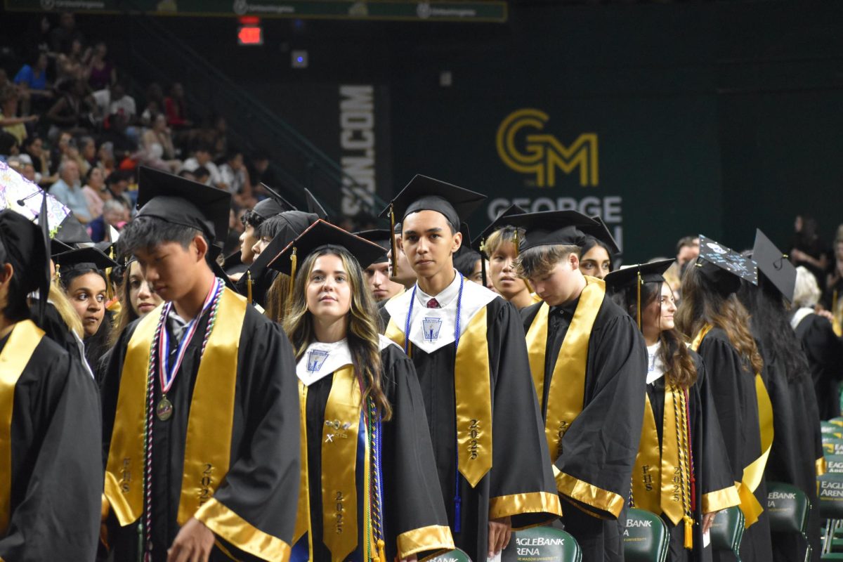 Jacob Yu, Ainsleigh Wood, Logan Thompson and other graduating seniors wait to take their seats for the ceremony. 