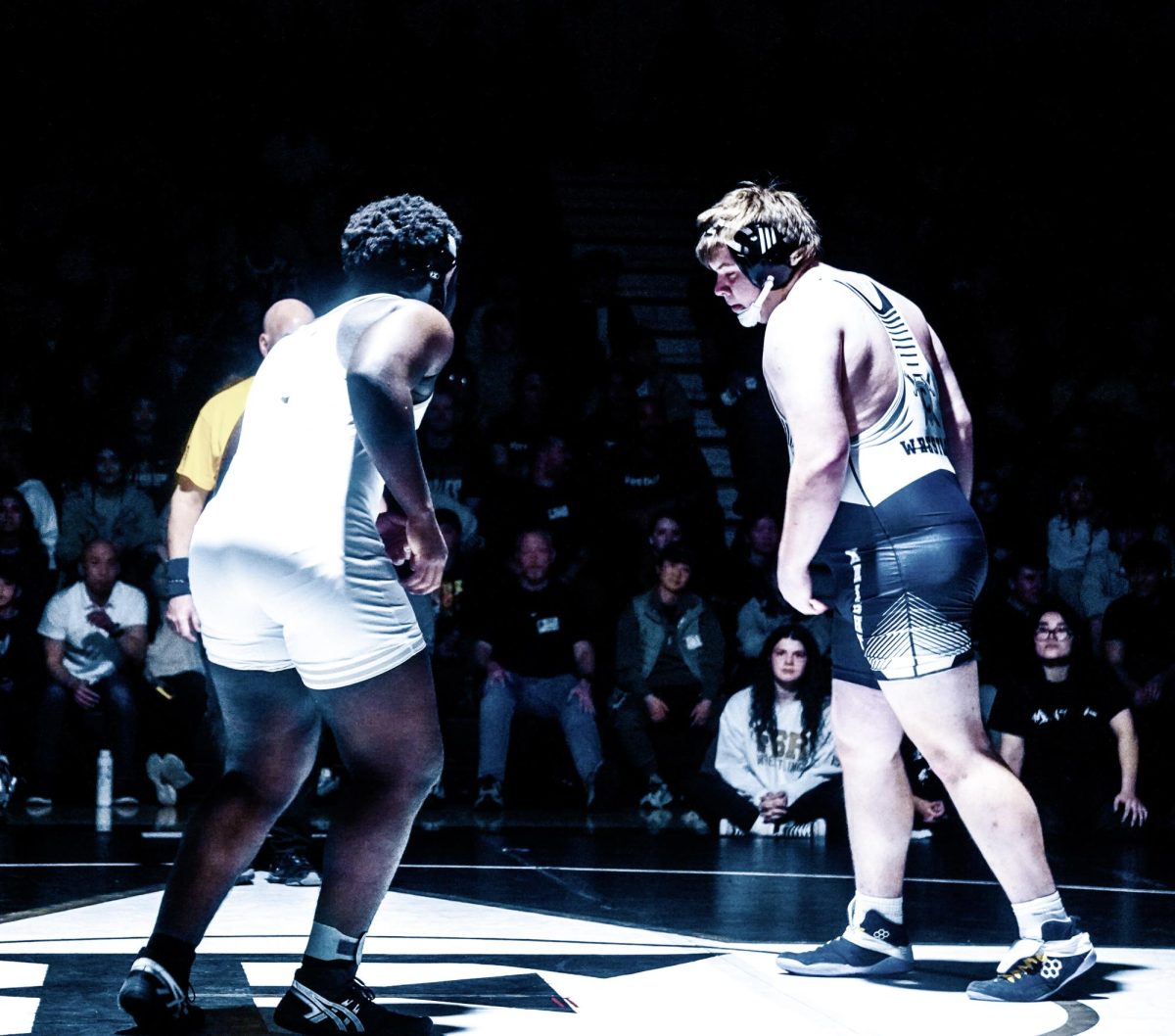 Junior Nana Arhin-Mensah prepares to wrestle against Champe wrestler.  