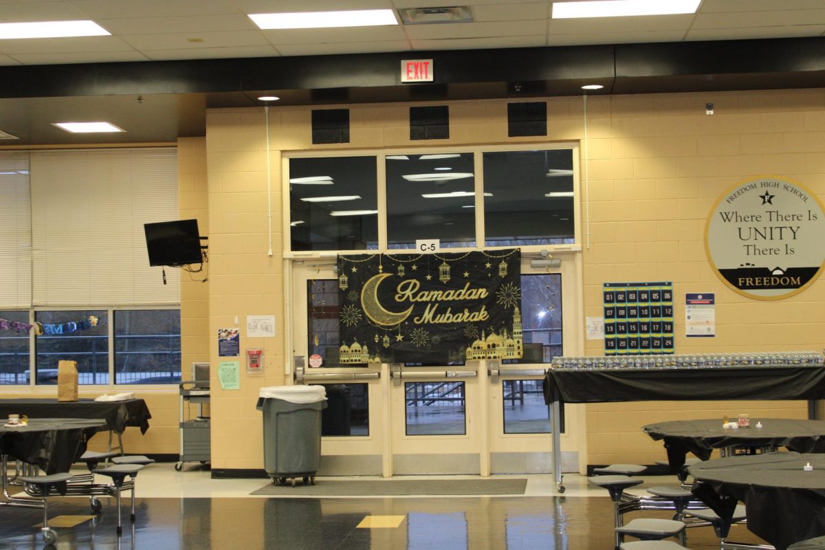 A "Ramadan Mubarak" banner taped along the doors of the cafeteria at the front of the MSA potluck.