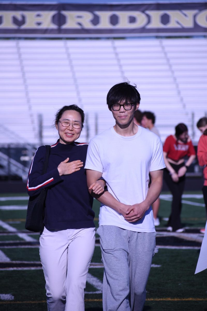 Senior Jiho Oh walking down the field during senior night.
