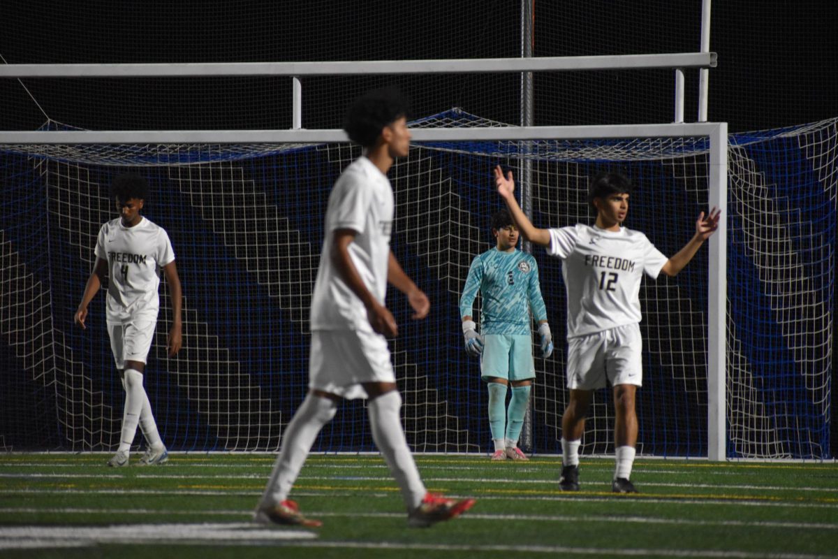 Freedom Boys Varsity Soccer working together.